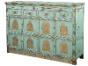 Tracy Porter\'s teal vintage chest, embellished with golden deities and Buddhas.
