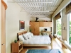 The second bedroom includes solar  shades and built-in pear wood cabinetry, closet and desk