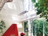 An open-concept atrium with skylight and large windows brightens the dining area and increases intimacy with nature