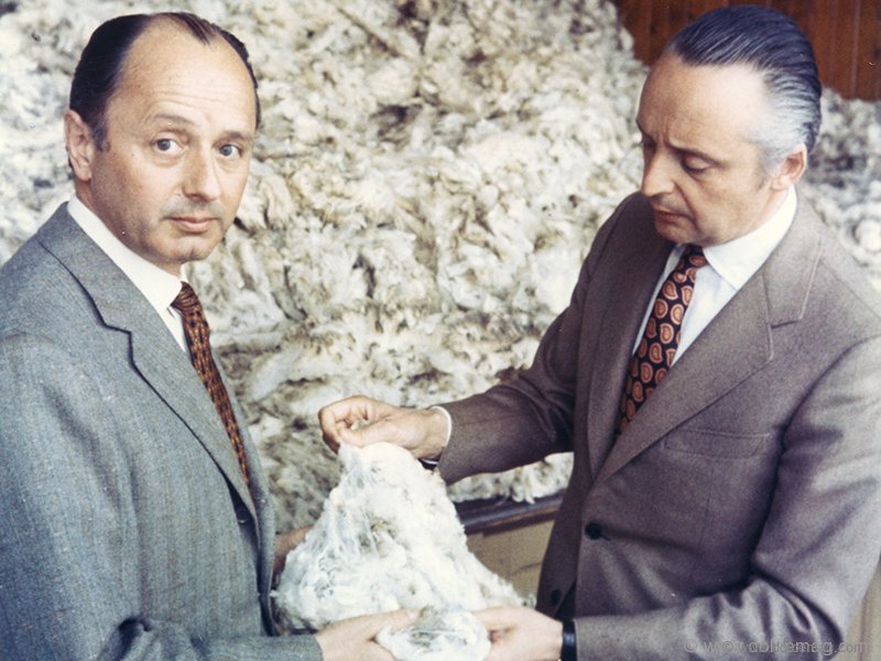 Aldo and Angelo Zegna, sons of Ermenegildo Zegna, inspect a piece of fine wool.