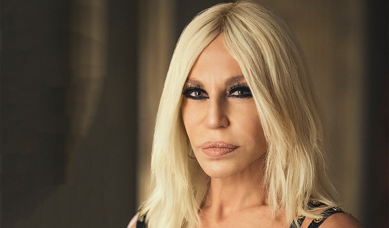 Donatella Versace with her collection of perfumes. Mind blowing